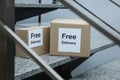 Parcels with stickers Free Delivery on stairs. Courier Royalty Free Stock Photo