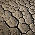 Parched, cracked earth forms a mosaic pattern on the ground, typical of drought- Royalty Free Stock Photo