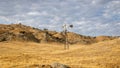 Parched farmland with yellow gold grass and rolling hills Royalty Free Stock Photo