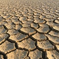 Parched ground with large, irregular cracks forming a mosaic-like pattern. The sun- Royalty Free Stock Photo
