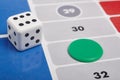 Parcheesi board game detail with dice and game piece Royalty Free Stock Photo