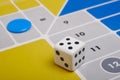 Parcheesi board game detail with dice and game piece