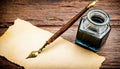 Parchment, quill and inkwell on a wooden table seen from above.