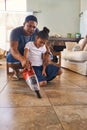 Parent, child and cleaning by vacuum floor of living room of house as teamwork to learning responsibility at home Royalty Free Stock Photo