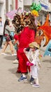 Parent and child in costume at the Diablada