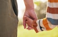 Parent, child and holding hands for walking in park for support, trust and care together or bonding in nature. Love Royalty Free Stock Photo