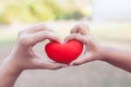 Parent and child holding red heart in hands and make heart shape Royalty Free Stock Photo