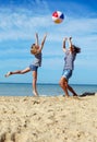 Parent and child play a ball at coast on a summer day Royalty Free Stock Photo