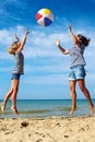 Parent and child play a ball at coast on a sunny summer day Royalty Free Stock Photo