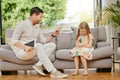 Parent, child and tablet with discipline on a sofa in the living room for naughty behavior at home. Upset, angry and Royalty Free Stock Photo