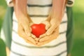 Parent and daughter holding heart in hands, closeup