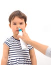 Parent of a girl applies a nasal spray isolated