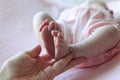 Parent hand hold baby girl legs Royalty Free Stock Photo