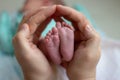 Parent holding hands feet. Newborn baby ankle Royalty Free Stock Photo