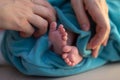 Parent holding hands feet. Newborn baby ankle Royalty Free Stock Photo