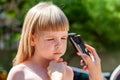 Parent, mother cutting her daughters hair using an electric hair trimmer, electrical hair clipper home use, simple shot