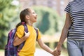 Parent and pupil go to school