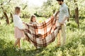 Parent swings child in plaid Royalty Free Stock Photo