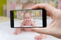 Parent is taking photo of a baby with smartphone Royalty Free Stock Photo