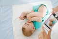 Parent taking photo of a baby with smartphone. Adorable newborn child taking foot in mouth Royalty Free Stock Photo