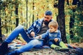 Parent teach baby. Happy Father and son with spending time outdoor in the autumn park. Both dad and child are laughing. Royalty Free Stock Photo