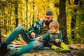 Parent teach baby. Happy Father and son with spending time outdoor in the autumn park. Both dad and child are laughing. Royalty Free Stock Photo