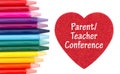 Parent Teacher Conference message on red heart with colored watercolor pencils