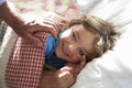 Parent Waking Young Boy Asleep In Bed Royalty Free Stock Photo