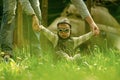 Parental care. Son baby in pilot helmet holding hands with mother