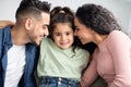 Parental Love. Happy Arabic Parents Cuddling Their Cute Little Daughter At Home Royalty Free Stock Photo