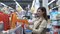 Parenthood, a caring young mother chooses a baby potty for child in malls childrens store