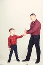 Parenthood concept. Fathers day. Father example of noble human. Cool guys. Father little son red shirts family look Royalty Free Stock Photo