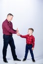 Parenthood concept. Fathers day. Father example of noble human. Cool guys. Father little son red shirts family look Royalty Free Stock Photo