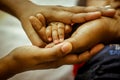 Parenthood Concept - Happy Mom and Dad are holding Baby Finger on hands. Parents are holding the hand and finger of a newborn baby Royalty Free Stock Photo