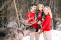 Parenthood, fashion, season and people concept - happy family with child in winter clothes outdoors Royalty Free Stock Photo