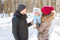 Parenthood, season and people concept - happy family with child in winter clothes outdoors Royalty Free Stock Photo