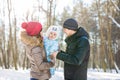 Parenthood, season and people concept - happy family with child in winter clothes outdoors Royalty Free Stock Photo