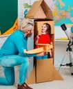 Parenting childhood. Childhood Dreams of space. Childin astronauts costumes with toy rocket playing and dreaming of Royalty Free Stock Photo