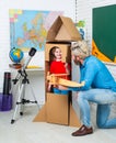 Parenting childhood. Childhood Dreams of space. Childin astronauts costumes with toy rocket playing and dreaming of Royalty Free Stock Photo