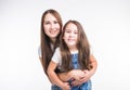 Parenting, family and children concept - Portrait of a mother and her baby girl have fun and smiling over white Royalty Free Stock Photo