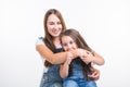 Parenting, family and children concept - Portrait of a mother and her baby girl have fun and smiling over white Royalty Free Stock Photo