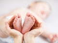 Parenting hands holding small baby's feet