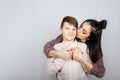 Parenting teen boys, Raising a teen. Studio portrait of Happy Teen boy hugging his mom Royalty Free Stock Photo