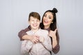 Parenting teen boys, Raising a teen. Studio portrait of Happy Teen boy hugging his mom Royalty Free Stock Photo