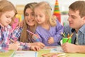 Parents with daughters drawing with pencils Royalty Free Stock Photo