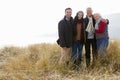 Parents With Adult Offspring Standing In Dunes Royalty Free Stock Photo