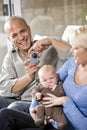 Parents with baby at home, dad holding camera Royalty Free Stock Photo