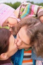 Parents with baby kiss outdoor Royalty Free Stock Photo