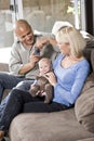 Parents and baby on lap at home, dad with camera Royalty Free Stock Photo