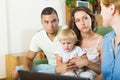 Parents and baby sitting in front of social worker